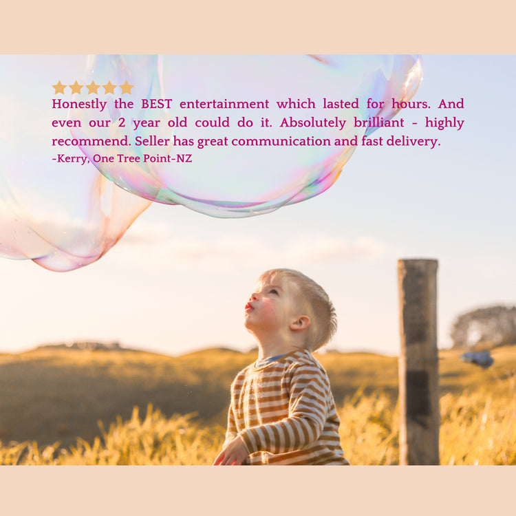 A toddler in a striped shirt blows a large iridescent bubble in an outdoor field at golden hour, with a review text overlay and star rating on a beige background.