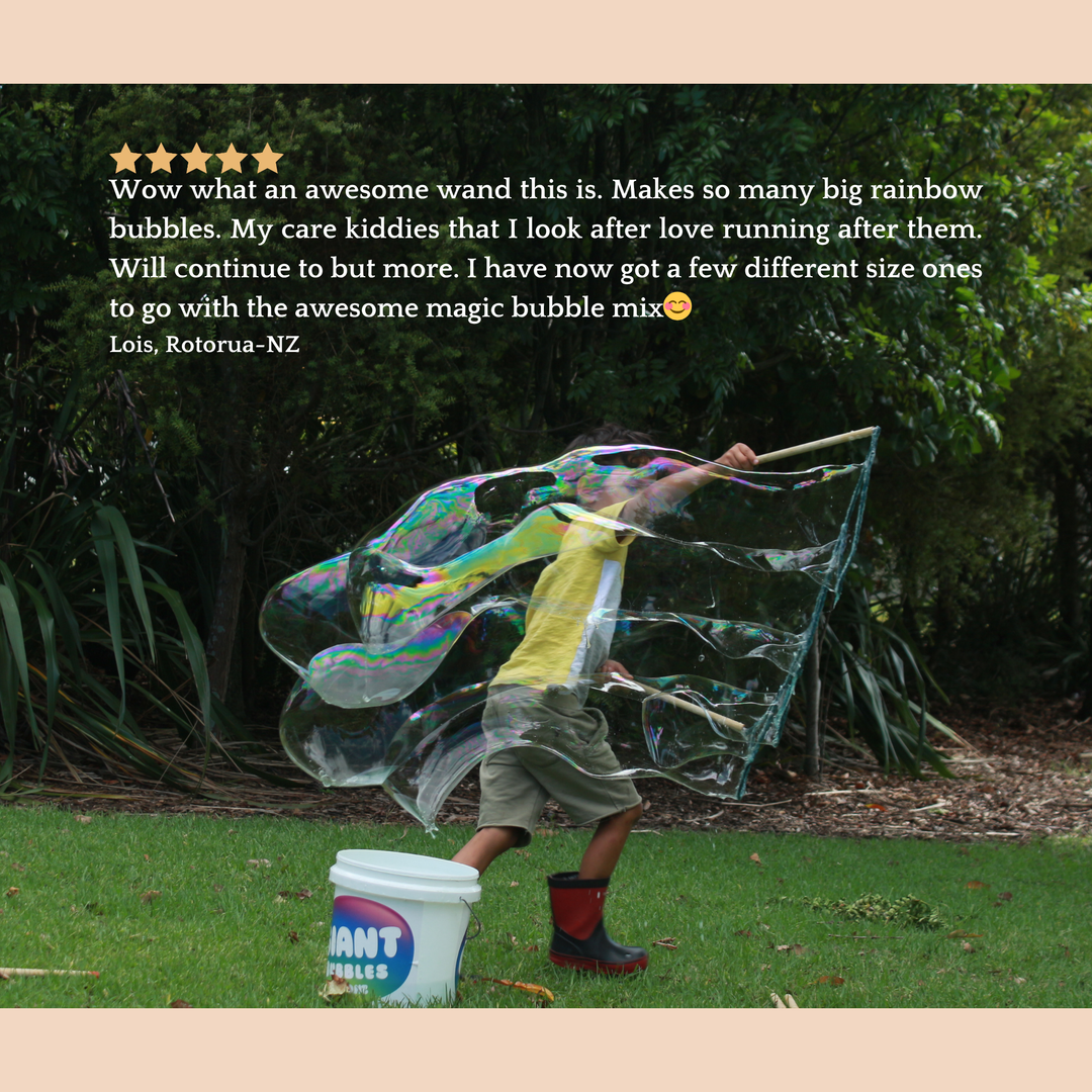 Child playing with bubble wand and bubbles in a garden, with a Giant Bubble product visible.