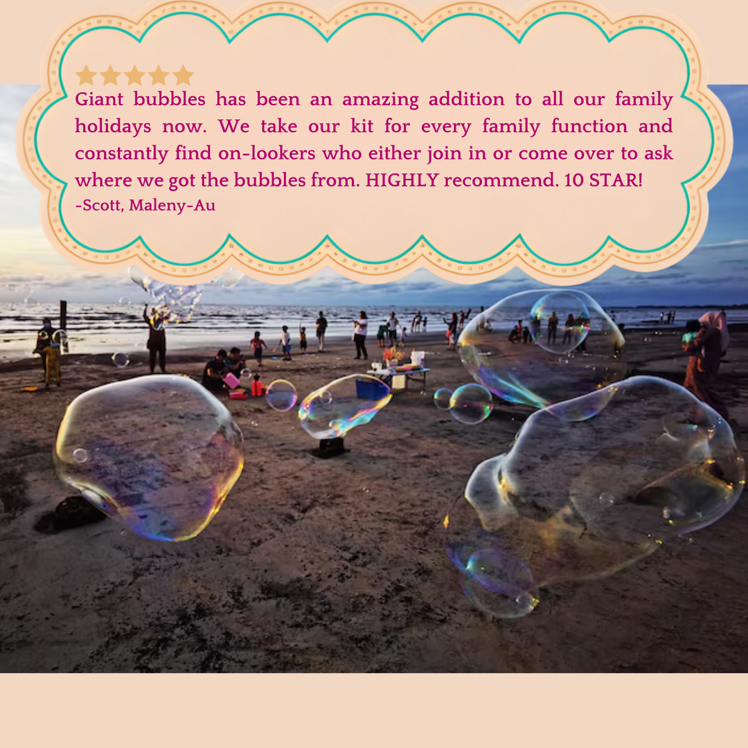 A crowd on the beach surrounded by lots of giant bubbles