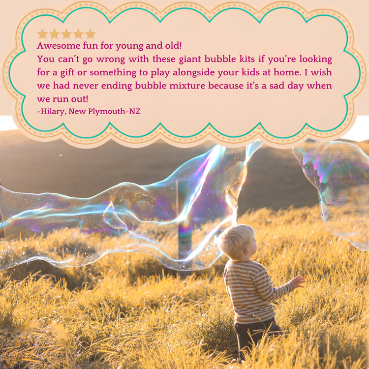 Child playing with giant bubbles in a field with a review quote overlay.