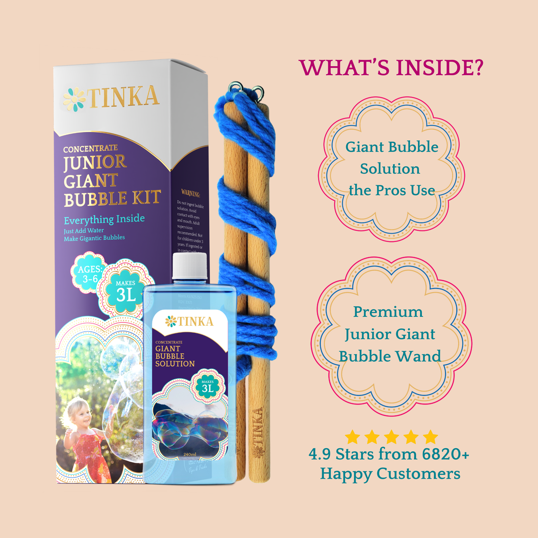 A purple and gold box by Tinka with a blue bottle of 240ml of bubble liquid and a blue bubble wand on a plain background.